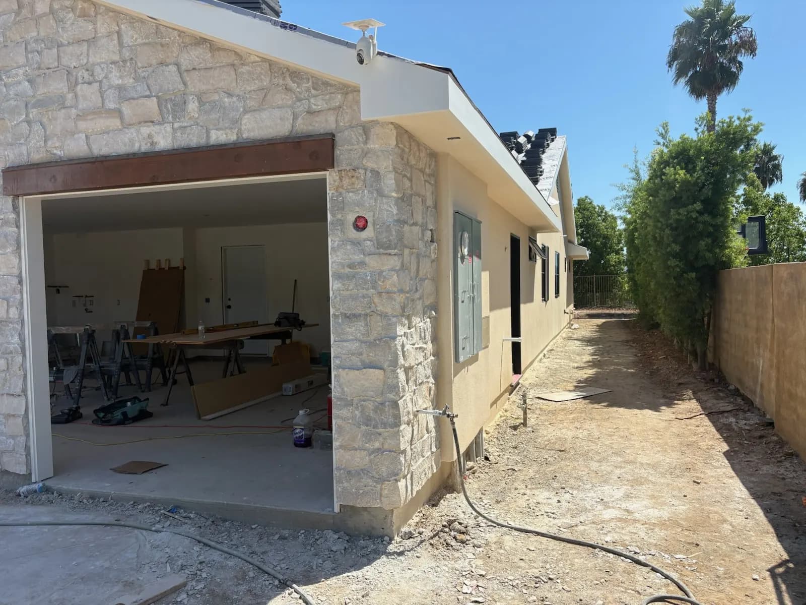 Stone veneer garage and exterior wall on a home under construction