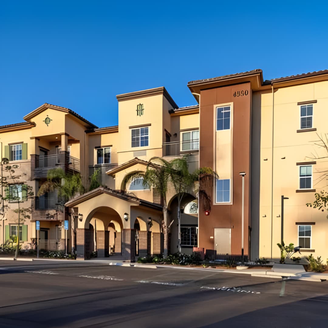 Apartment complex with trees and parking area